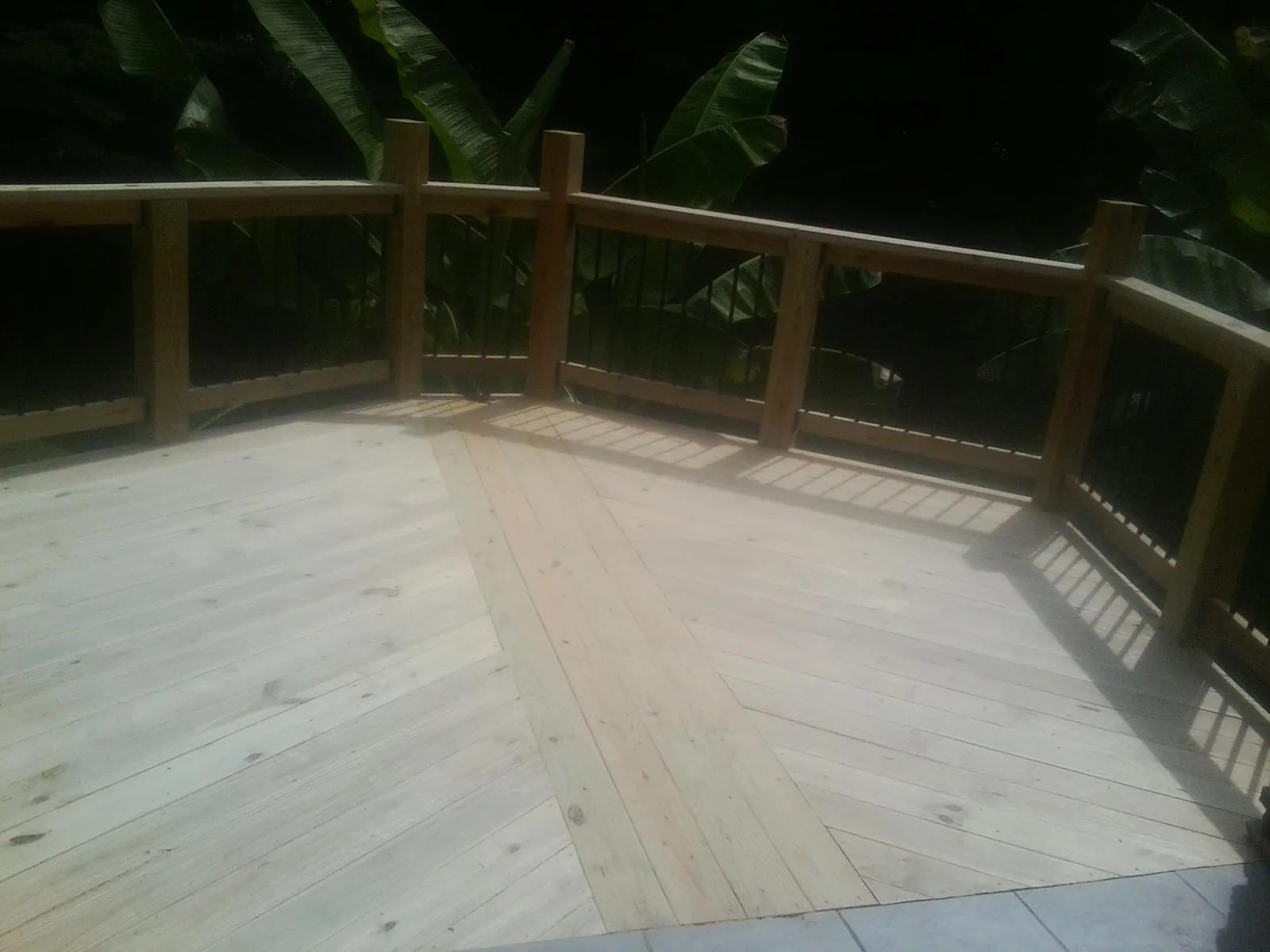 New wood deck and railing built off the back of a home in Metairie