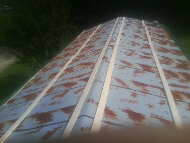 Rusted metal roof panels with new wood purlins before replacement — Storm Damage Roof Repair in Metairie by Roofing Brothers